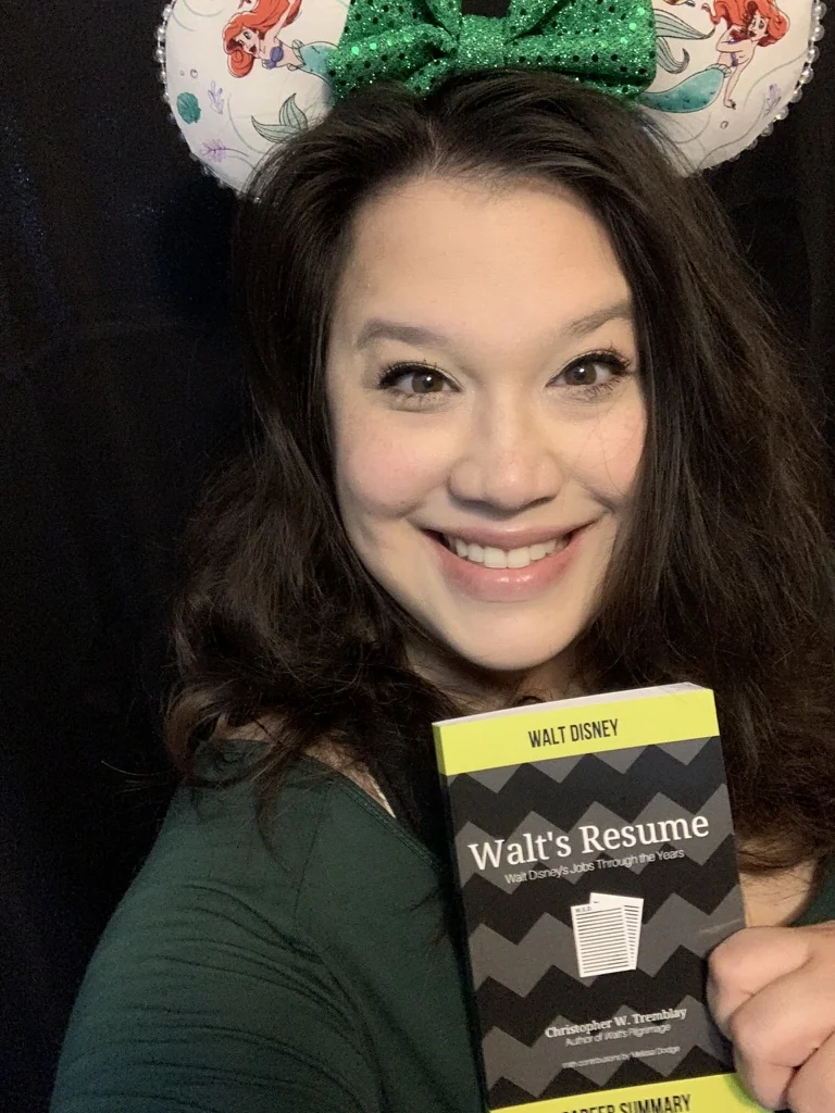 Missy holding Walt's Resume, a book she edited