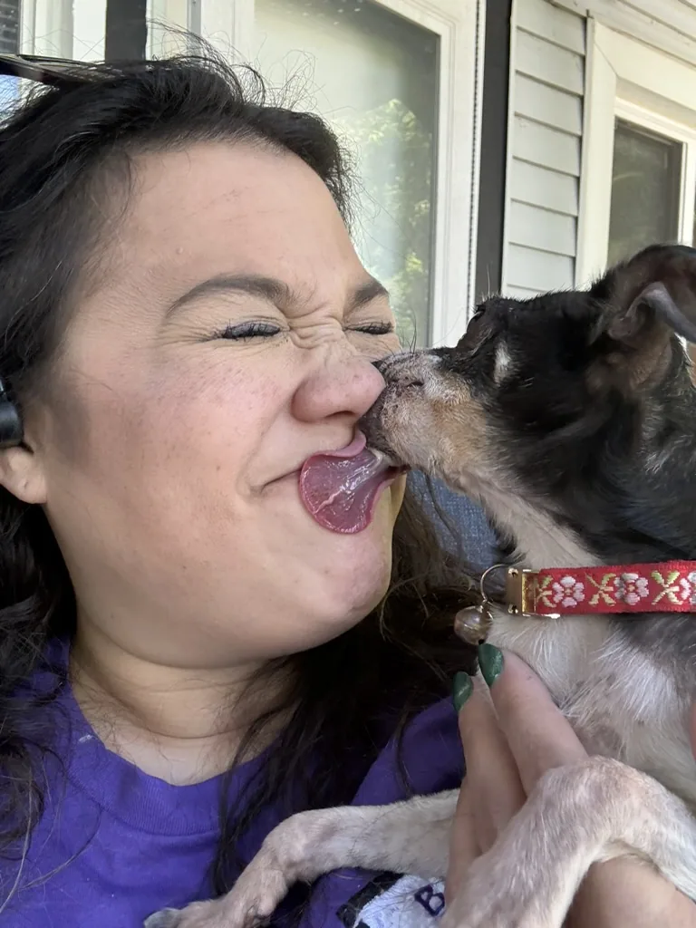 Missy receiving an enthusiastic dog kiss