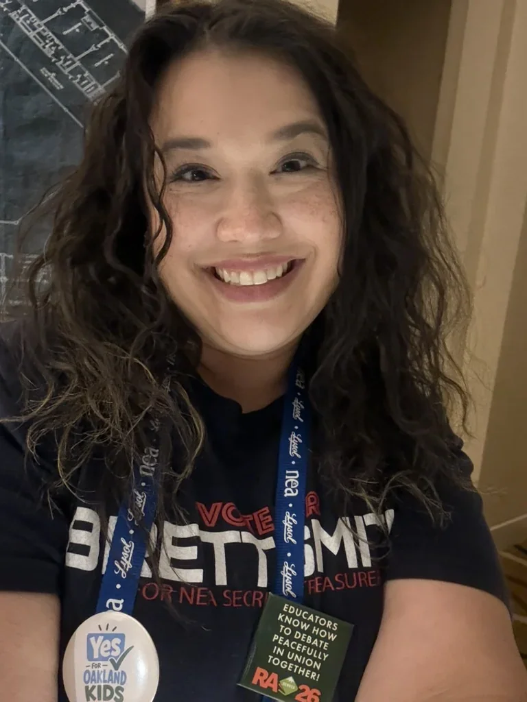 Missy at the MEA Winter Conference with her NEA lanyard and Yes for Oakland Kids button